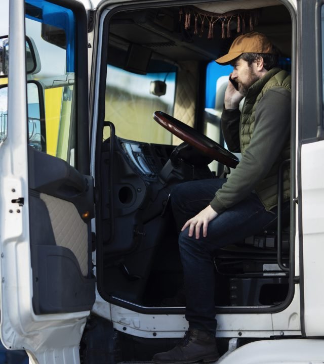 full-shot-man-sitting-truck